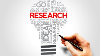 Word cloud shaped like a light bulb with the word "research" large and in red