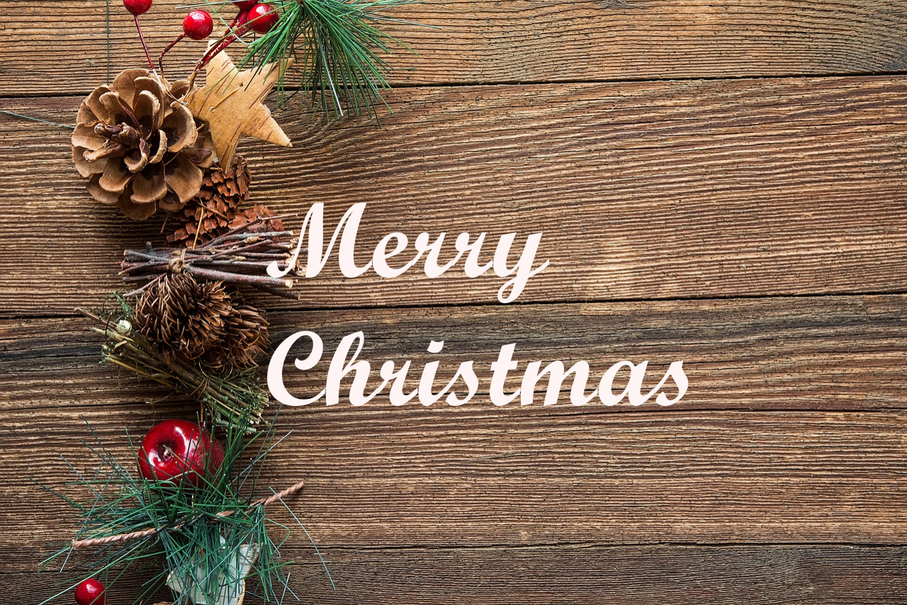 A wooden background with a border of pinecones and berries. Text reads Merry Christmas