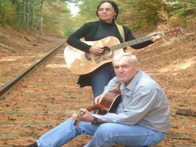 Andy & Judy Folk singers standing on railroad track