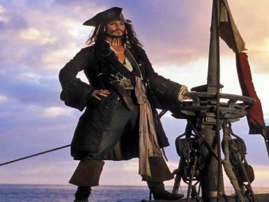 Pirate Jack Sparrow standing at the helm.