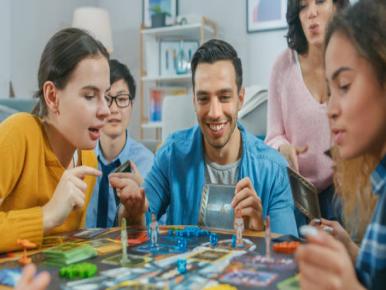 Family playing board game at table