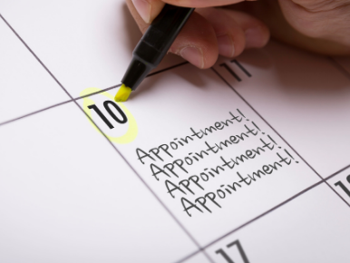 Picture of a calendar with a hand and a pen circling the word appointment