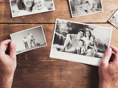 two hands holding up family photos