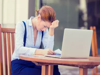 Woman stressed at learning computer program.